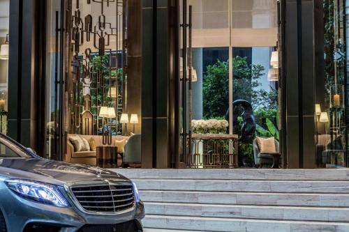 a car parked in front of a building at Waldorf Astoria Bangkok in Bangkok