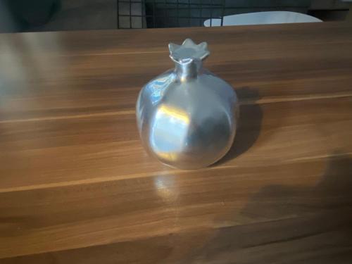 a glass vase sitting on top of a wooden table at Little Home in Potos