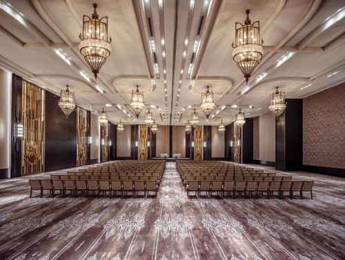 an empty banquet hall with chairs and chandeliers at Waldorf Astoria Bangkok in Bangkok