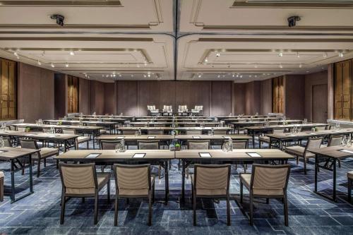an empty conference room with tables and chairs at Waldorf Astoria Bangkok in Bangkok