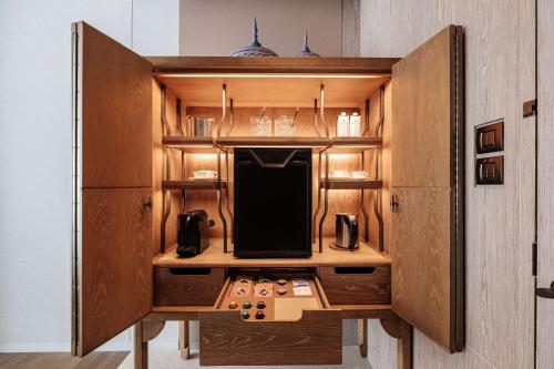 a kitchen with wooden cabinets with a desk in it at Waldorf Astoria Bangkok in Bangkok