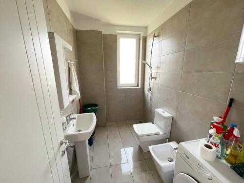 a bathroom with a sink and a toilet at Talea Coast Apartment in Lezhë