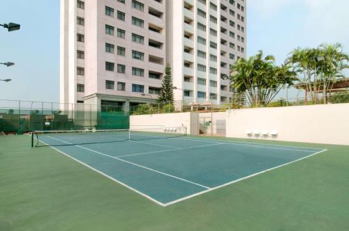 a tennis court in front of a building at Hilton Colombo Residence in Colombo