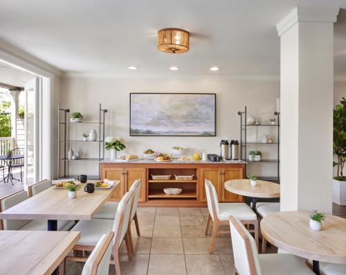a dining room with two tables and a buffet at Inn at Sonoma, A Four Sisters Inn in Sonoma