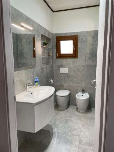 a bathroom with a sink and a toilet at LA SCALINATA in Portoferraio