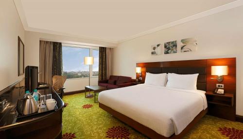 a hotel room with a bed and a television at Hilton Garden Inn New Delhi/Saket in New Delhi