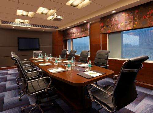a conference room with a large wooden table and chairs at Hilton Garden Inn New Delhi/Saket in New Delhi