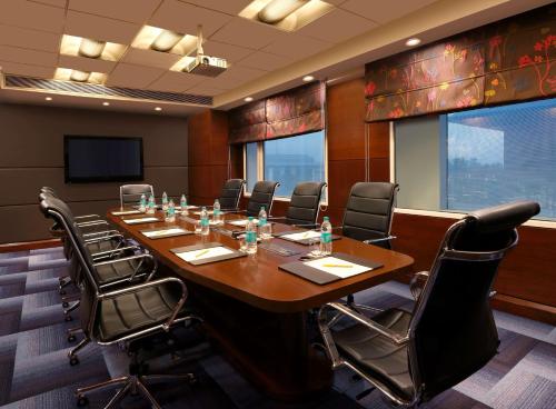 a conference room with a large wooden table and chairs at Hilton Garden Inn New Delhi/Saket in New Delhi
