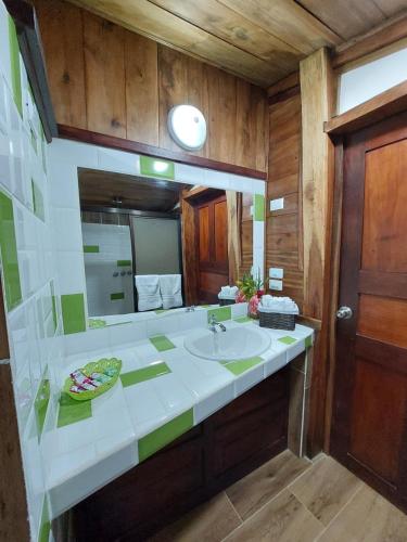 a bathroom with a sink and a mirror at Casa Mairena in Caño Negro