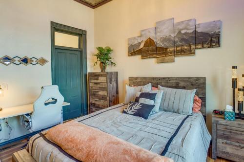 a bedroom with a bed and a desk and a mirror at Downtown Montrose Apartment, 12 Mi to Natl Park! in Montrose