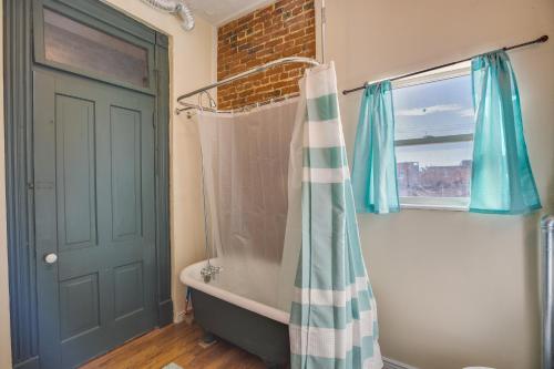 a bathroom with a bath tub and a shower curtain at Downtown Montrose Apartment, 12 Mi to Natl Park! in Montrose