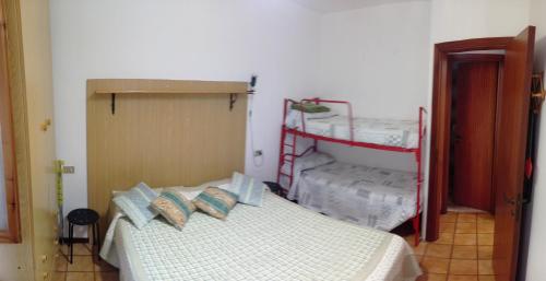 a bedroom with a bed and two bunk beds at CASA MASSI in Caramanico Terme