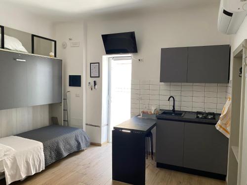 a kitchen with a sink and a bed in a room at Affittacamere Sanbenedetto in San Benedetto del Tronto