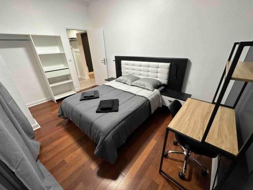 a bedroom with a large bed and a table at Appartement entier proche de Paris. in Pavillons-sous-Bois