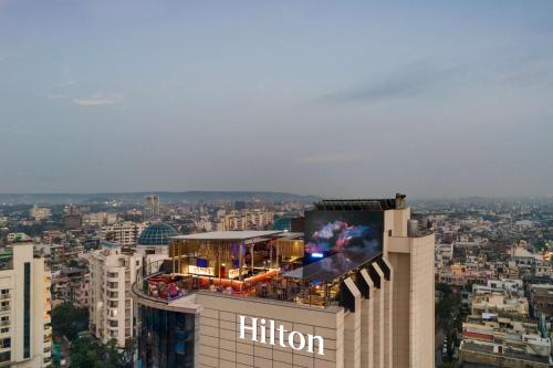 a building with a billboard on top of it at Hilton Jaipur in Jaipur