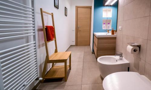 a bathroom with a sink and a toilet and a mirror at Marina di Piazzadarmi in Ancona