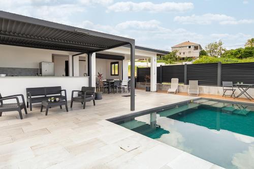 a house with a swimming pool and a patio at KAY SE MI in Case-Pilote