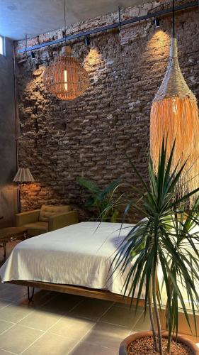 a bedroom with a bed and a brick wall at CASA PATRICIA in Oaxaca City