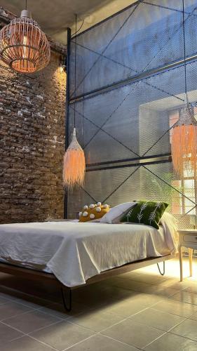 a bedroom with a bed and a brick wall at CASA PATRICIA in Oaxaca City