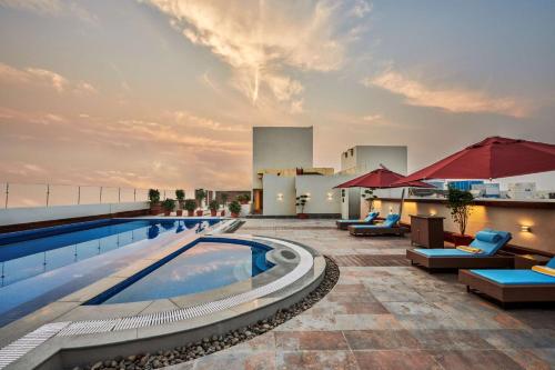 a swimming pool on the roof of a building at Hilton Garden Inn Lucknow in Lucknow
