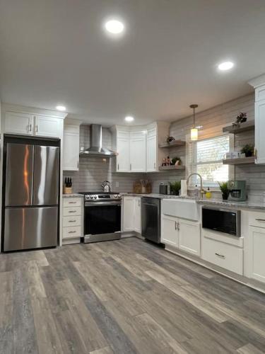 a kitchen with white cabinets and stainless steel appliances at Freshly-remodeled, dog-friendly Westwood charmer! in Westwood