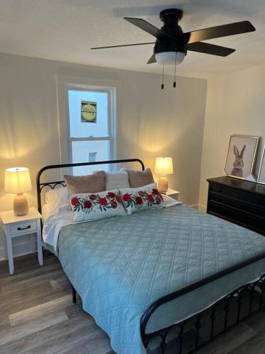 a bedroom with a bed and a ceiling fan at Freshly-remodeled, dog-friendly Westwood charmer! in Westwood