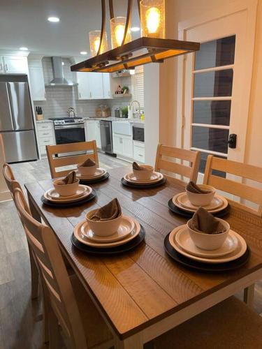 a wooden table with plates and bowls on it in a kitchen at Freshly-remodeled, dog-friendly Westwood charmer! in Westwood