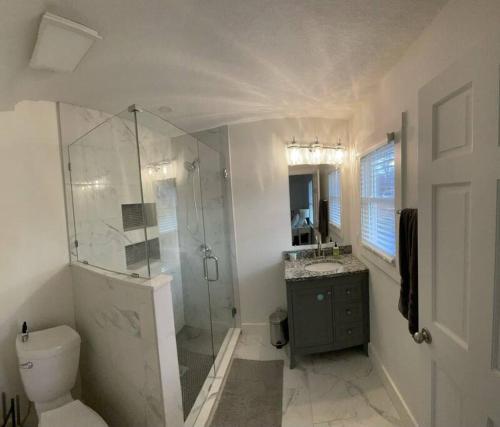 a bathroom with a shower and a toilet and a sink at Freshly-remodeled, dog-friendly Westwood charmer! in Westwood