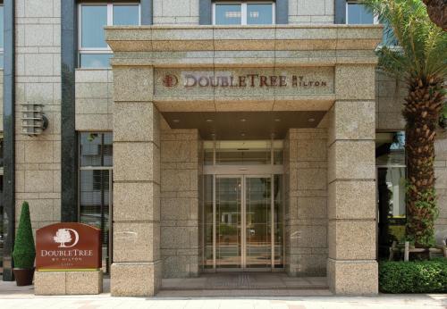 a building with the door to a doubletree hotel at DoubleTree by Hilton Hotel Naha in Naha
