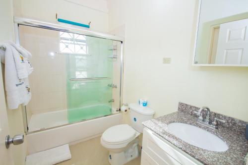 a bathroom with a toilet and a shower and a sink at Ocho Rios Emerald 2 Bed 10 mins ocho Rios 24hrs Hot Water Wi fi in Ocho Rios