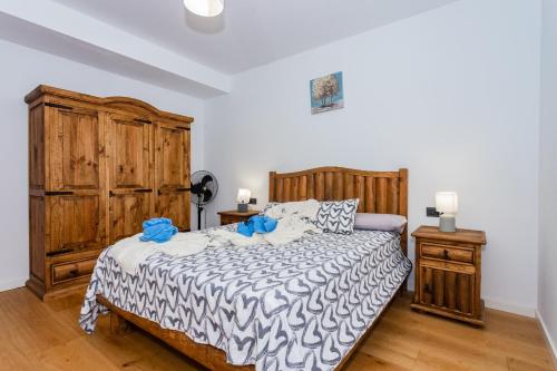 a bedroom with a large bed and a wooden cabinet at Villa Casa Blanca in Playa Blanca