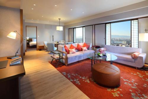 a living room with a couch and a table at Hilton Osaka Hotel in Osaka