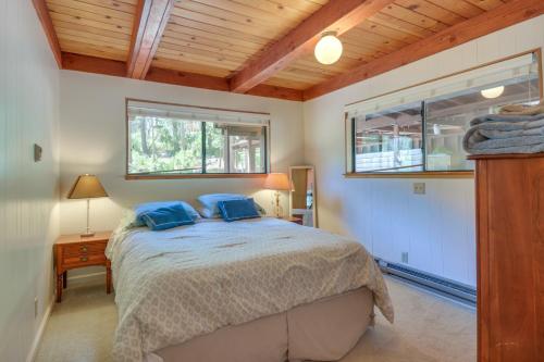 a bedroom with a bed with blue pillows on it at Quiet 1 BR and Loft Home about 6 Mi to Yosemite in Groveland