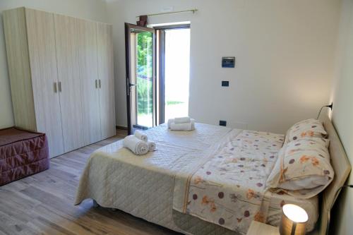 a bedroom with a bed with two towels on it at U Casale in Finocchito