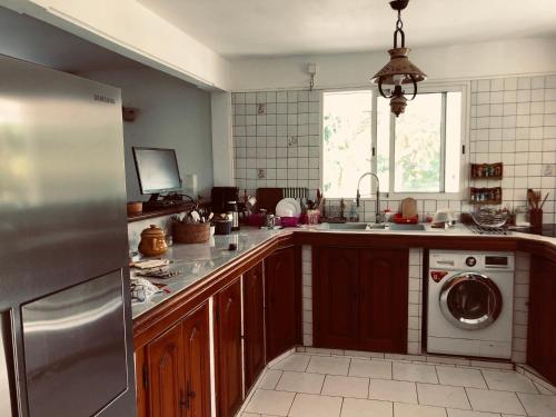 a kitchen with a sink and a dishwasher at Ti Vanillier in Petit-Bourg