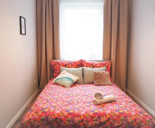 Una cama con un montón de almohadas y una ventana en Republiki, en Cracovia