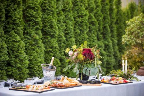 a table with several plates of food on it at Chateau On The Park - Christchurch, A Doubletree By Hilton in Christchurch