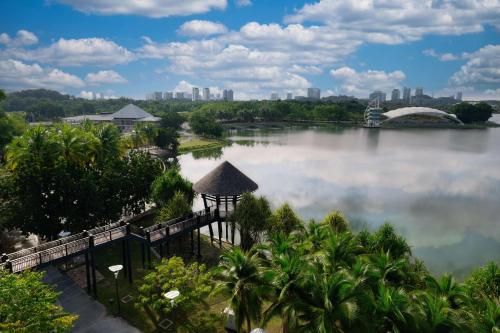 a view of a lake with a city in the background at DoubleTree by Hilton Putrajaya Lakeside in Putrajaya