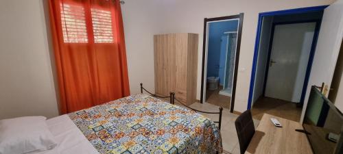 a bedroom with a bed and a mirror at Villa Rosetta - Casa Vacanze in Palmi