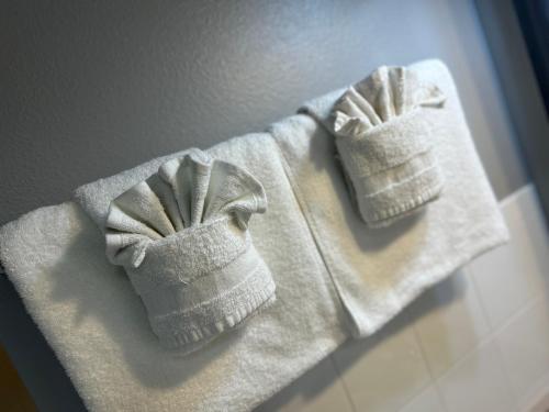 dos toallas blancas sentadas encima de un mostrador en Sails Resort Motel, en St Pete Beach