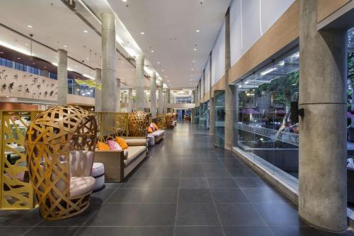 a store with couches and chairs in a shopping mall at Hilton Garden Inn Bali Ngurah Rai Airport in Kuta