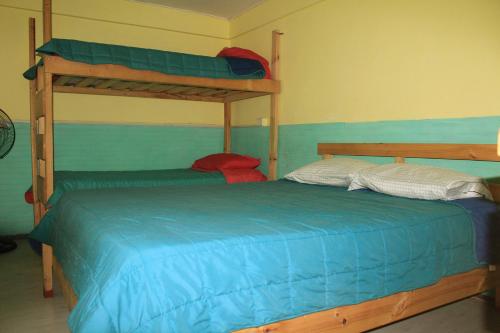 Ένα ή περισσότερα κρεβάτια σε δωμάτιο στο Hostel Posada de Gallo