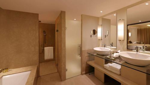 a bathroom with two sinks and a shower at DoubleTree by Hilton Agra in Agra