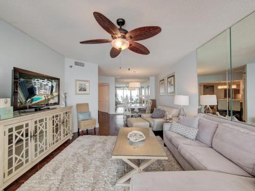 a living room with a couch and a ceiling fan at Pelican Pointe 1505 by Vacation Homes Collection in Orange Beach