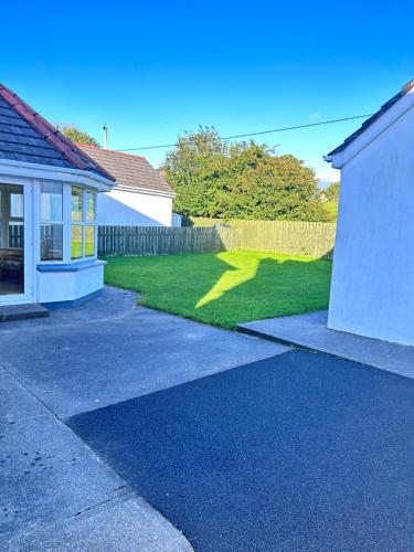 a driveway leading to a house with a yard at Dunalinn, Culdaff in Culdaff