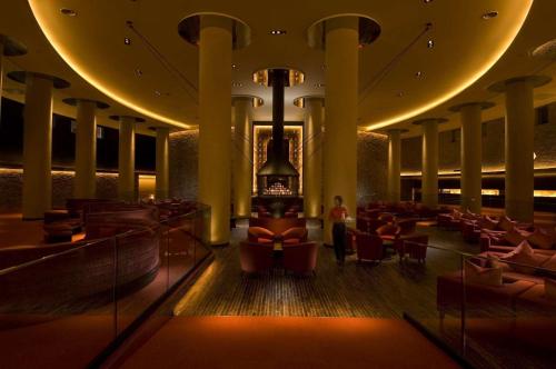 a lobby of a hotel with chairs and a person at Hilton Niseko Village in Niseko