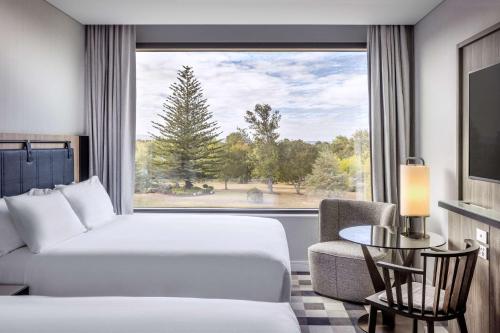 a hotel room with a bed and a window at Doubletree By Hilton Karaka in Auckland