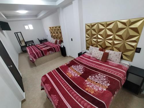 Postel nebo postele na pokoji v ubytování HOTEL EL ENCANTO