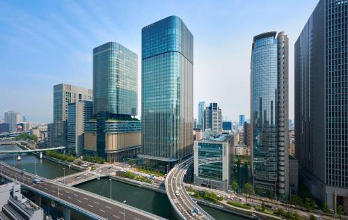 a city with many tall buildings and a highway at Conrad Osaka in Osaka