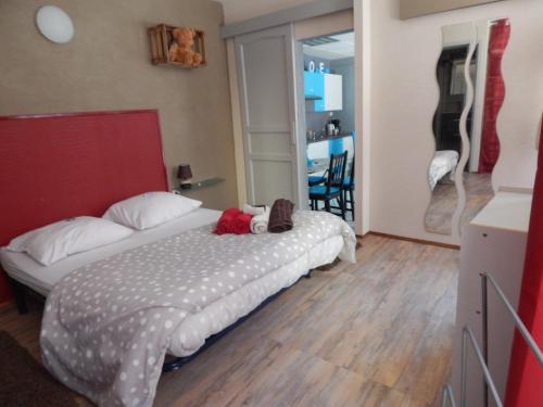 a bedroom with a bed and a guitar on the wall at Au Coup de Cœur in Colmar